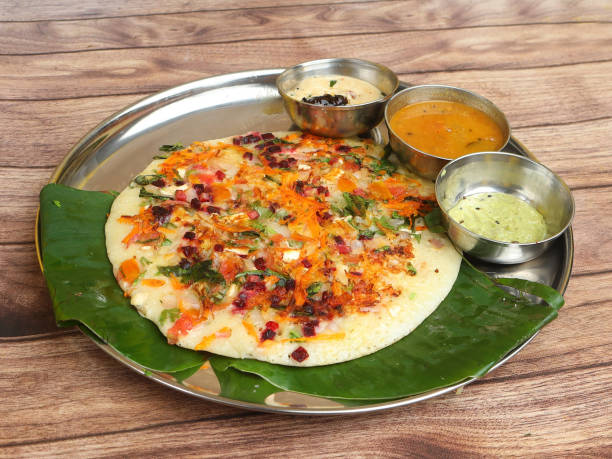 famous south indian food uttapam or ooththappam is a dosa like dish made by dosa batter, served with coconut chutney and sambar, selective focus - tamil imagens e fotografias de stock