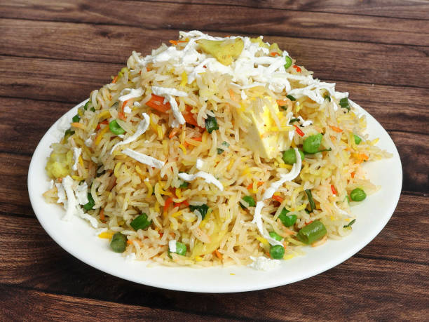 istock Veg pulao cooked with masala spices, served over a rustic wooden background, selective focus 1292631349