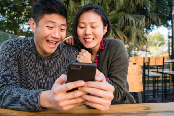 istock Asian couple looking at the mobile phone. 1292632050