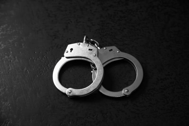 istock andcuffs on the black table 1292634378