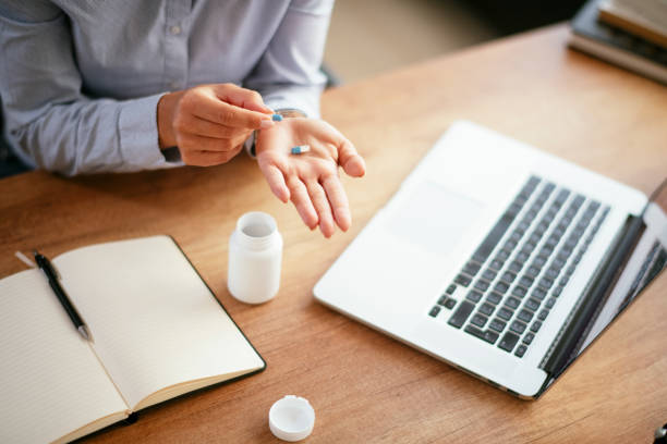 istock Businesswoman drinking medicine pill. 1292635135