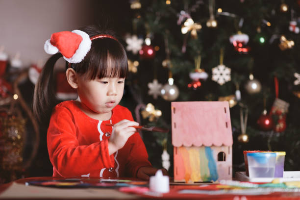 istock young girl making Christmas craft at home 1292635320