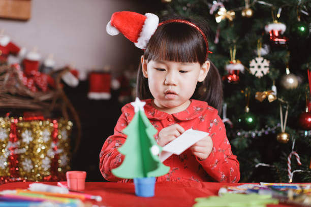 istock young girl making Christmas craft at home 1292635448