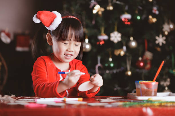 istock young girl making Christmas craft at home 1292635455