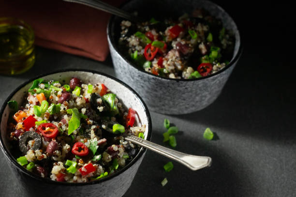 istock Two bowls with quinoa, paprika, beans and olives 1292635465