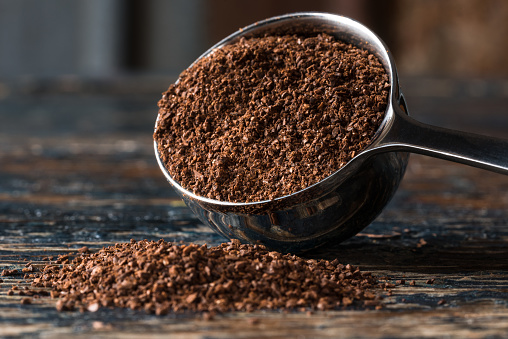 Ground Coffee Beans Spilled from a Coffee Scoop