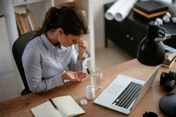istock Businesswoman drinking medicine pill. 1292636606