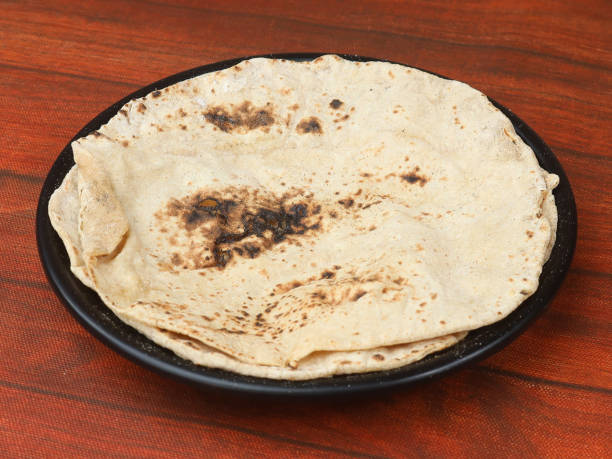 istock Tandoori Roti, isolated over a rustic wooden background, selective focus 1292638441