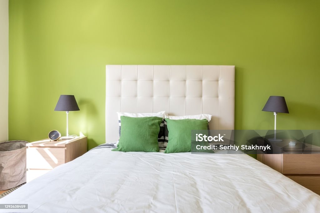 Modern bedroom in white and green colors. European hotel design and inside. Modern bedroom in white and green colors. European hotel design and inside Green Color Stock Photo