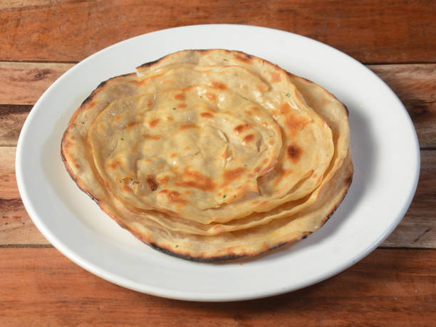 istock Lachha Paratha, a layered flat bread using wheat flour, popular dish in north India. isolated over a rustic wooden background, selective focus 1292639021