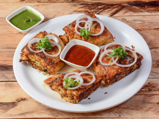 chicken baida roti, isolated over a rustic wooden background, selective focus