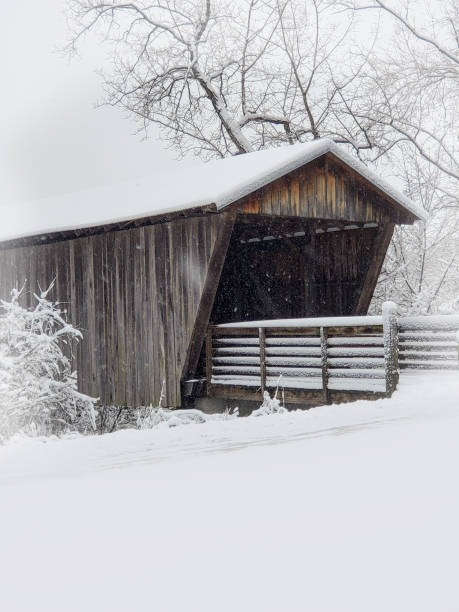 istock Old Wooden Covered Bridge during a Snow Storm 1292639496