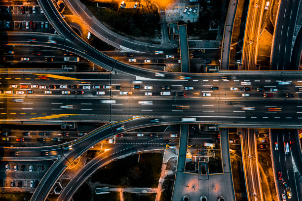 istock Multiple lane road intersection seen at night directly from above 1292639511