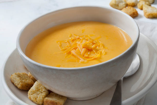 Creamy Cheddar Cheese Soup with Croutons Creamy Cheddar Cheese Soup with Croutons cheese sauce stock pictures, royalty-free photos & images