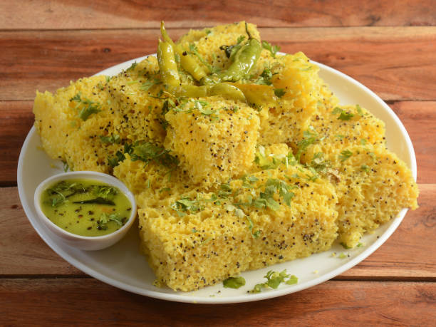 istock Indian Gujarati Khaman Dhokla made using Dal, served with Green chutney, selective focus 1292641405