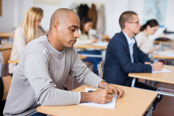 istock Focused man working at adult education class 1292641406