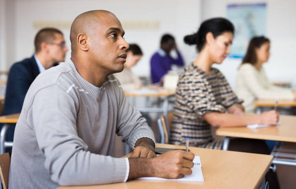 istock Focused man working at adult education class 1292641422