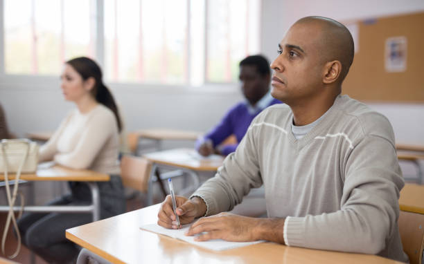 istock Focused man working at adult education class 1292648091