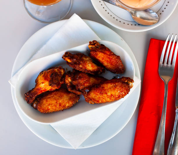 istock fried hot chicken wings on white plate for brunch 1292648197