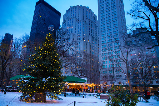 New York City, New York, USA  - December 19. 2020: Madison Square Park in midtown Manhattan NYC seen in the evening during the 2020 Christmas holiday season with people visibl