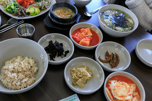 Rice bownl soup bowl and side dishes in korean restaurant