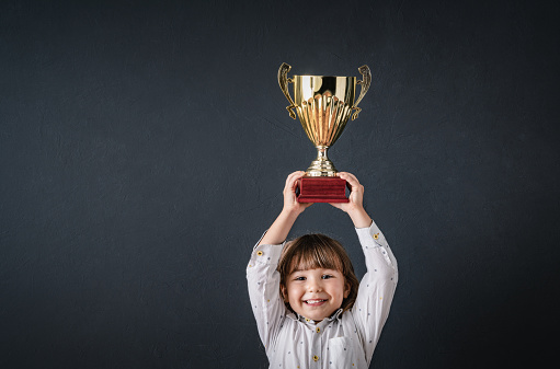 Brass steel trophy, dual handle neo-classic, isolated on white. Trophy is a tangible, durable reminder of a specific achievement, serves as recognition / evidence of merit, awarded for sporting events