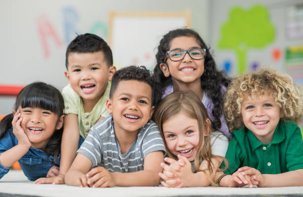 istock Multi ethnic preschool children laughing and smiling 1292652382