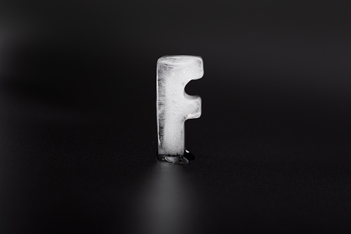 Ice letter F on black background.