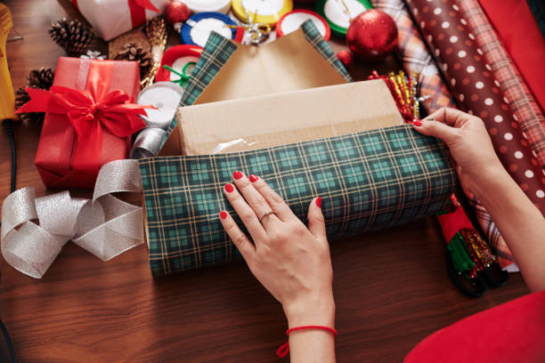 istock Woman wrapping Christmas present 1292658756
