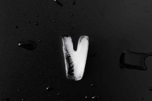 Ice letter V on black background.