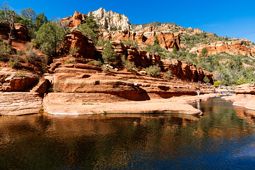 Coconino, Arizona USA - October 17, 2016: Visitors enjoying the beauty of Slide Rock State Park with its natural rock water slides in the Oak Creek Canyon near Sedona.