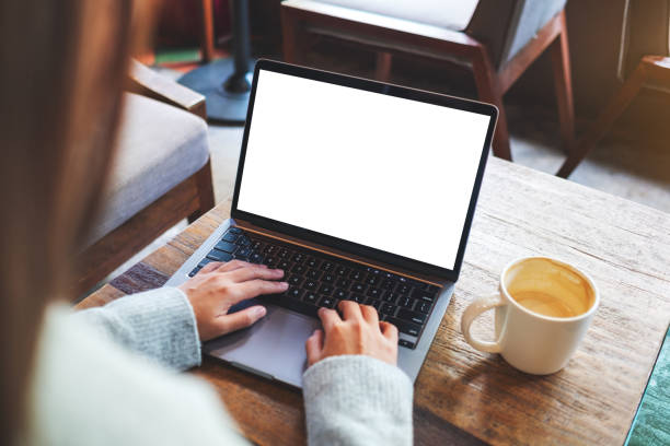 istock a woman using and typing on laptop computer keyboard with blank white desktop screen 1292666472