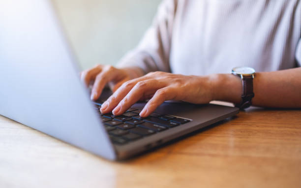 istock a woman working and typing on laptop computer keyboard on wooden table 1292666475