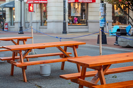 Victoria, Canada - October 30, 2020. Outdoor seating expands into the street to encourage social distancing during the COVID-19 pandemic.