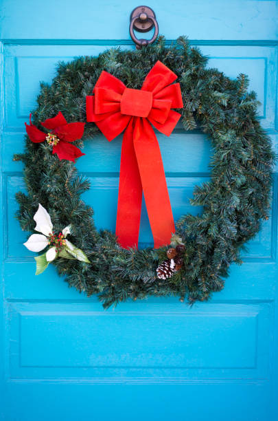 istock Santa Fe Style: Green Christmas Wreath, Red Bow, Blue Door 1292669953