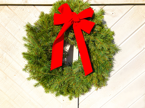 Green Christmas Wreath, Red Bow, Rustic Door. Shot in Santa Fe, NM.