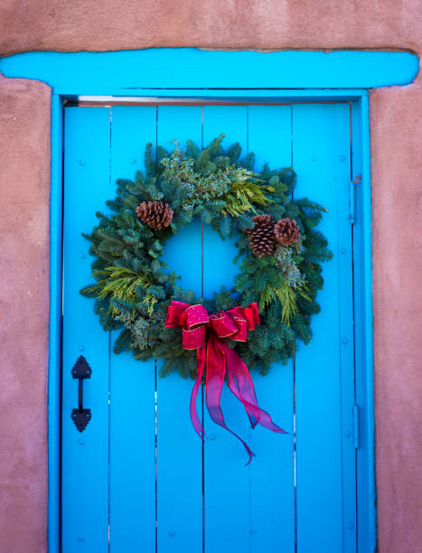 istock Santa Fe Style: Green Christmas Wreath, Red Bow, Blue Door 1292670618