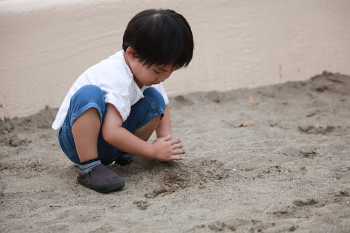 Boy playing in the sandbox