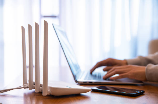 istock Internet router with man working on laptop 1292675597