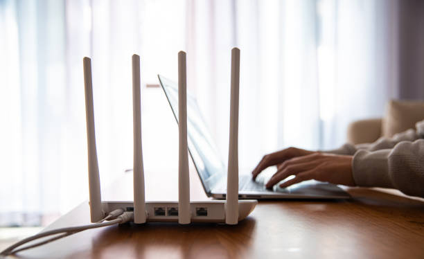 istock Internet router with man working on laptop 1292675627
