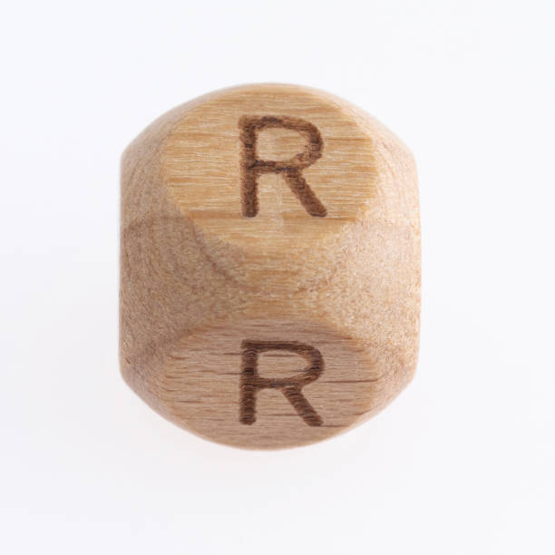 istock Wood dice with letter R on white background 1292679447