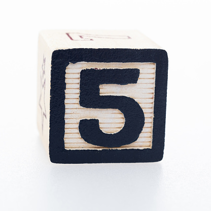 Wooden toy block with number 5.