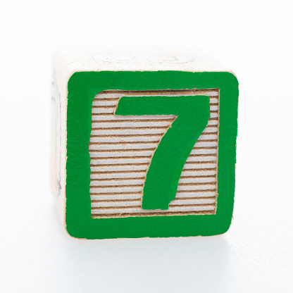 Wooden toy block with number 7.