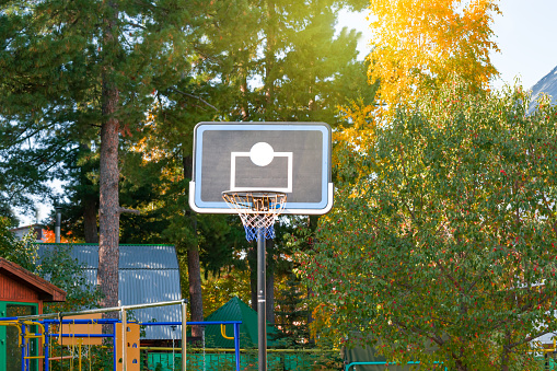 Basket with a net for playing basketball on a Board in the courtyard of a residential building in the city. The theme of a healthy lifestyle, playing outdoor sports