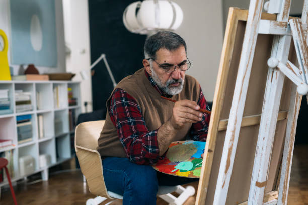 istock senior man painting picture 1292688402