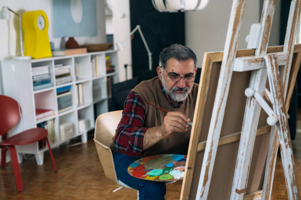 istock senior man painting picture 1292689312