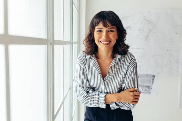 istock Smiling businesswoman in office 1292689502