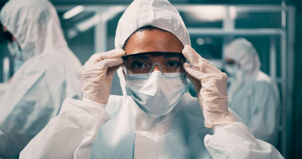 istock Ethnic medical practitioner in hazmat suit 1292690390