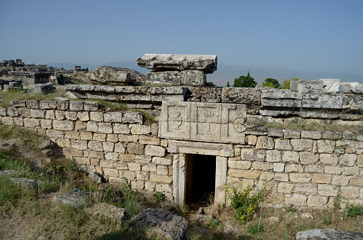 Remains of funeral monuments, necropolis in Hierapolis,  Pamukkale ,amphora and circle picture on the wall.