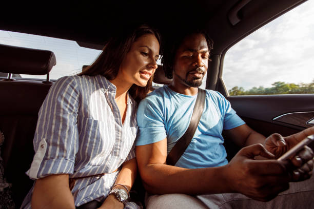 istock Looking at photos on smart phone while driving in a car 1292696519